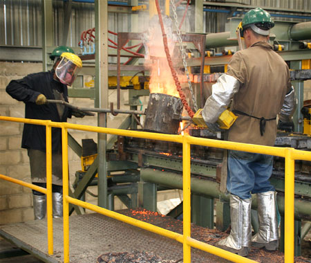 cast-foundrya CAST Lighting foundry - pouring bronze into sand molds for landscape lighting fixtures