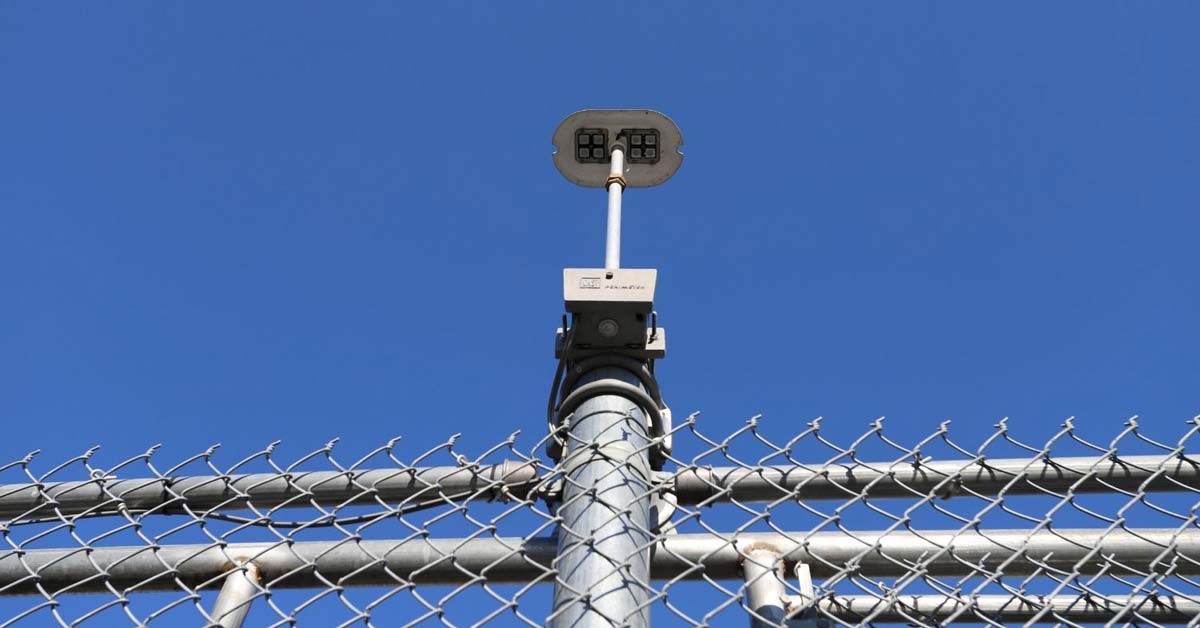 light-on-top-of-chain-link-fence-day