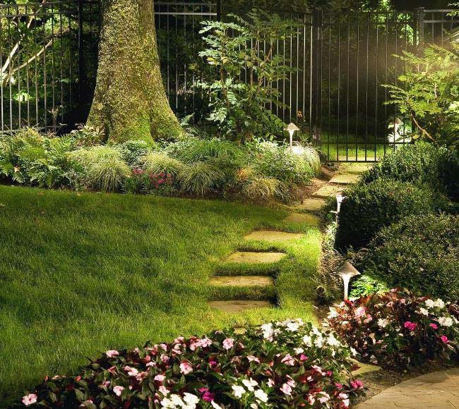 paving stones in a lush green garden illuminated by Short China Hat Outdoor Lights