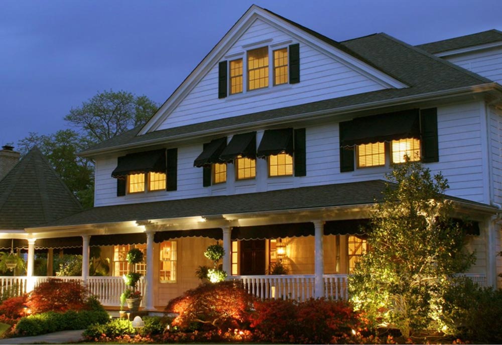 White house with porch lights on at night